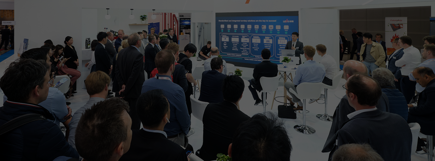 Exhibitor showing attendee product at tradeshow