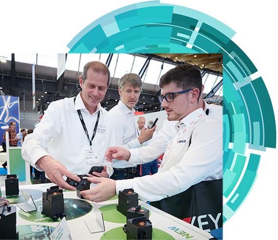 An exhibitor explaining his product to an attendee